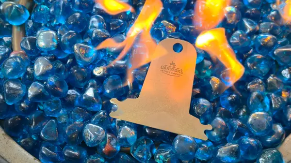 OakStoke bristle-free grill scraper surrounded by fire and blue glass stones