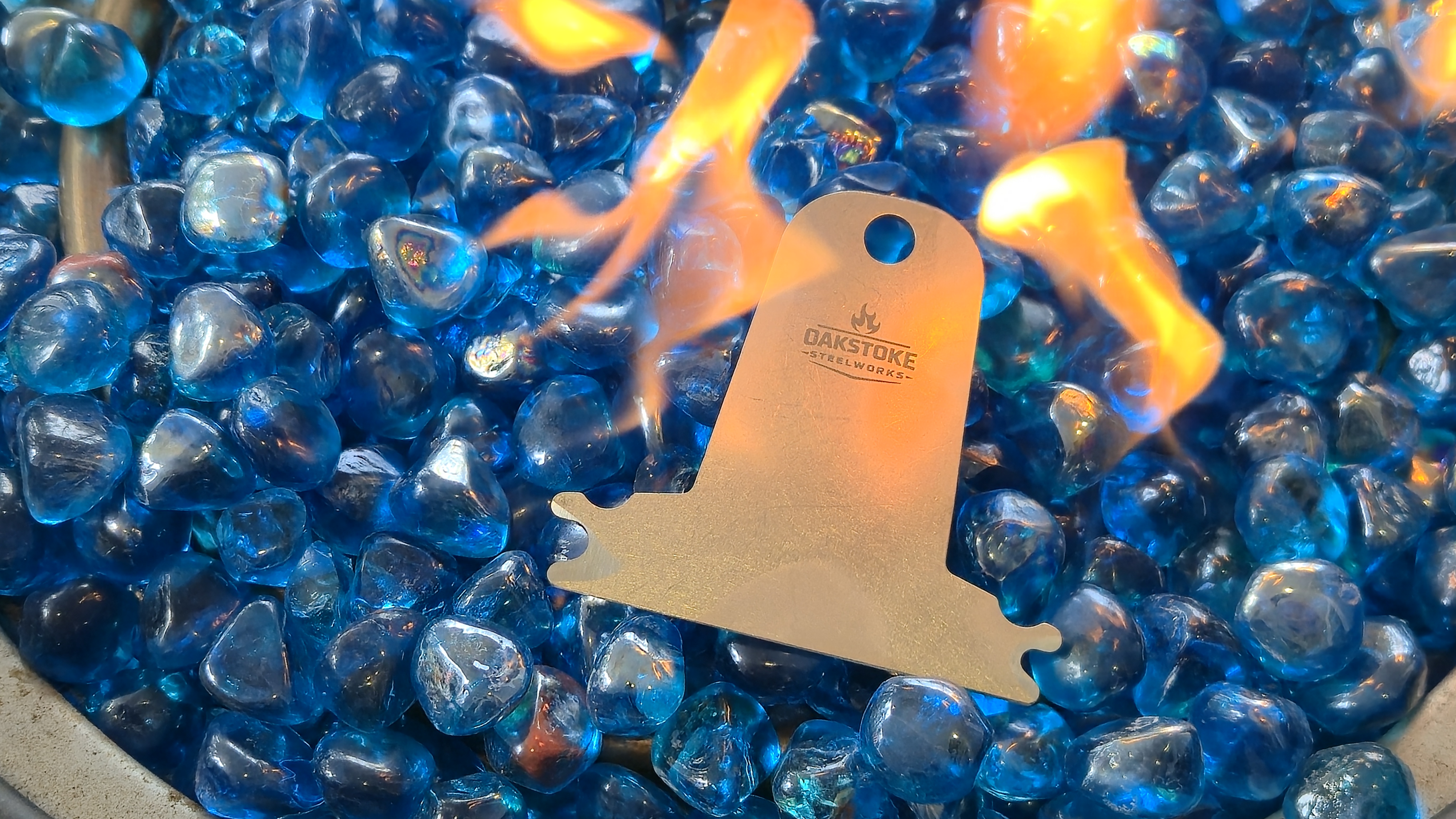 OakStoke bristle-free grill scraper surrounded by fire, solid 304 stainless steel made in USA